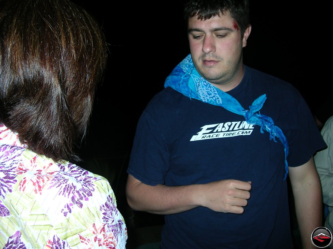 man wearing a sling made from a bandana