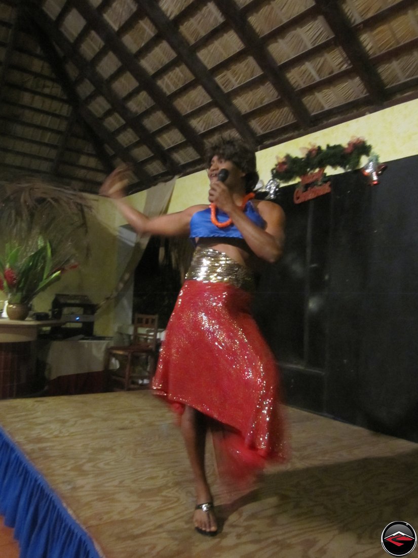 Man dressed as a woman singing to entertain guests La Tambora Beach Resort