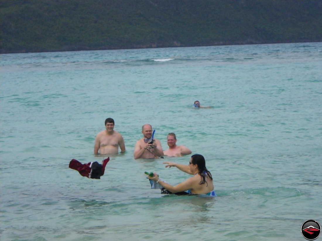 Men throwing their swimsuits onto the beach Playa Rincon Dominican Republic