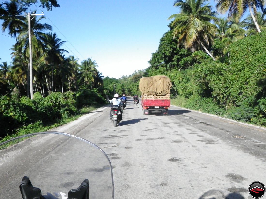 motorcycle passing trucks