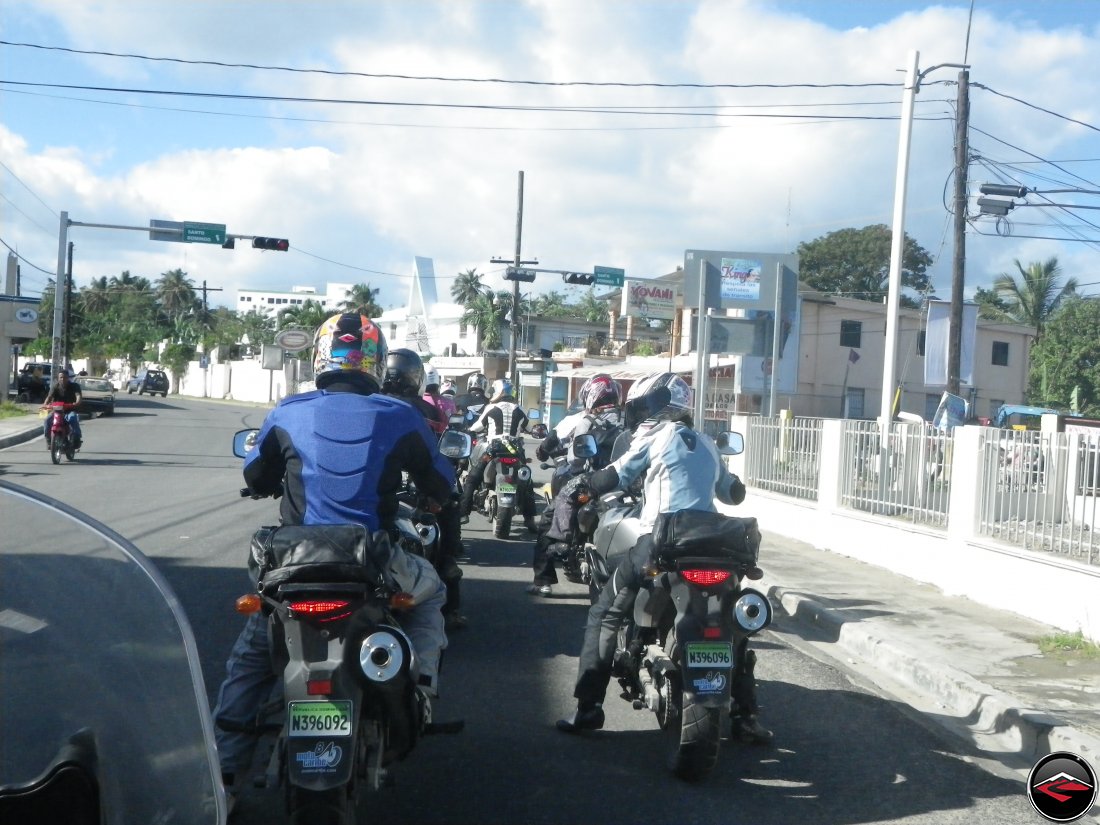 motorcycles stopped at a light in a caribbean town