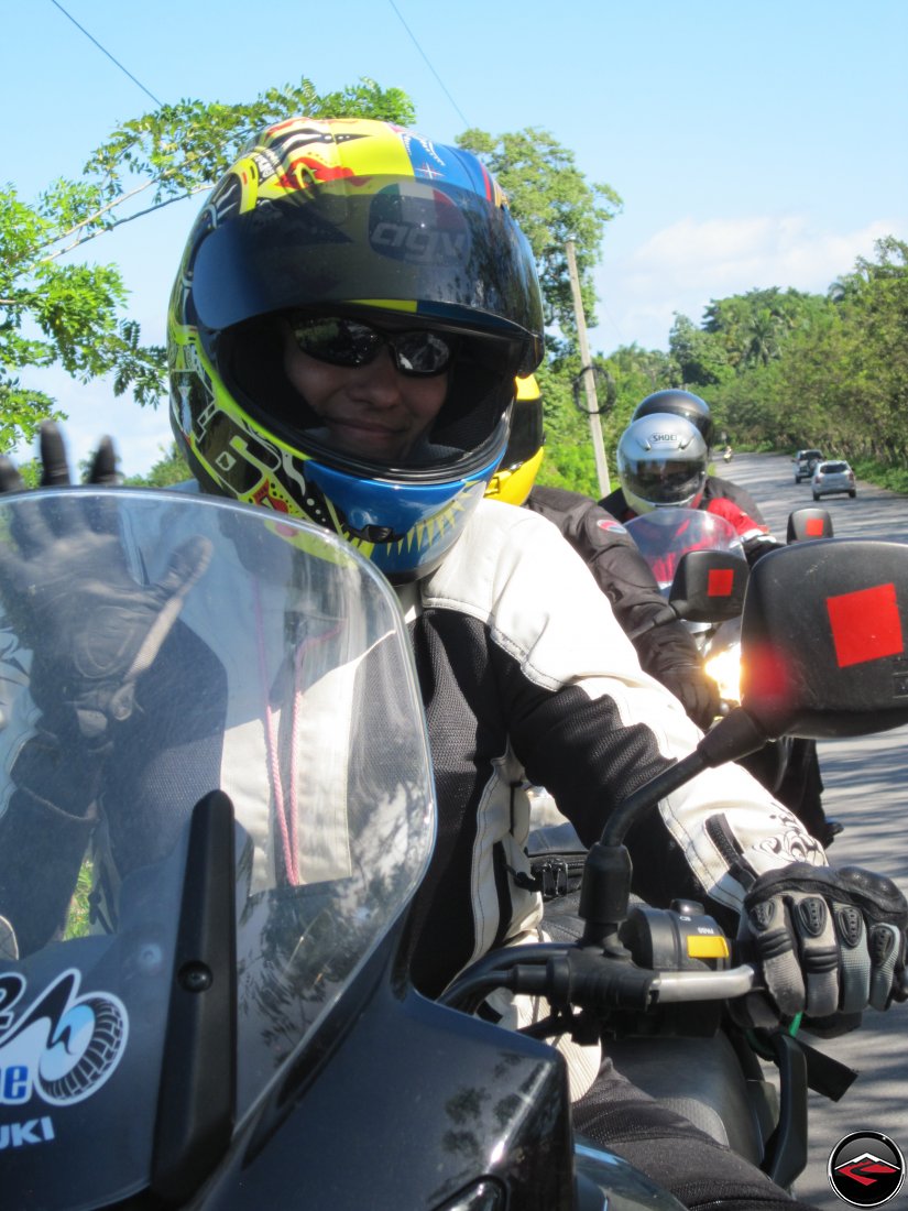 woman wearing a motorcycle helmet waving