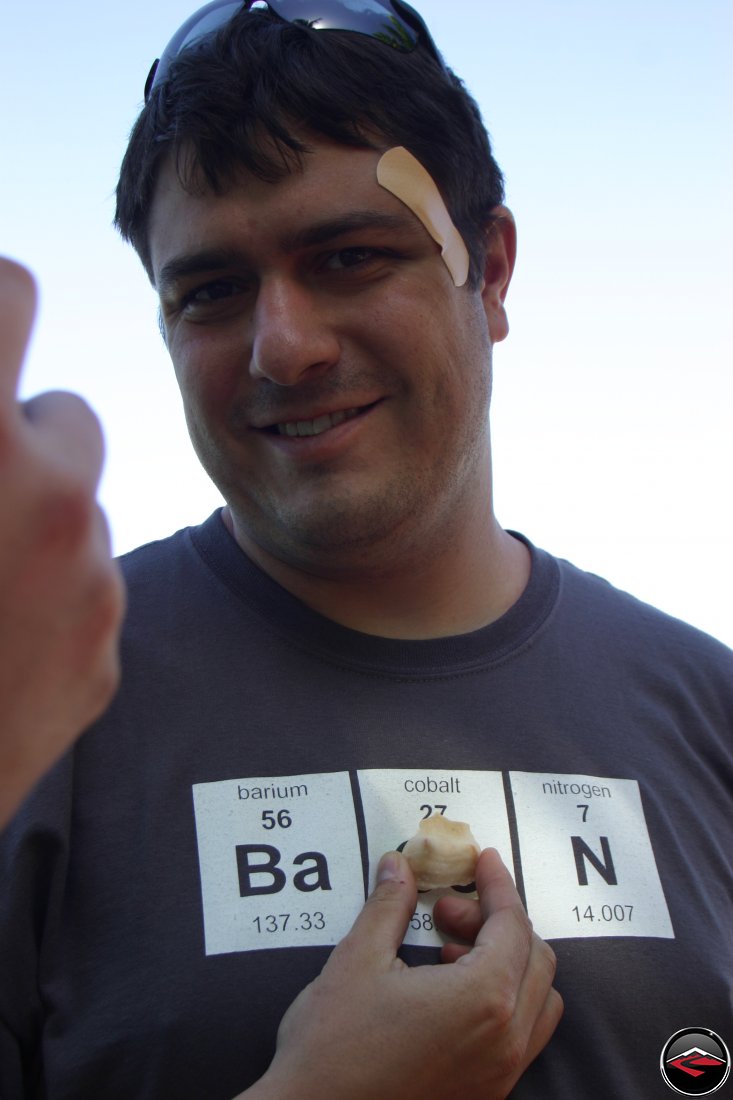 man holding a sea shell that looks like a boob