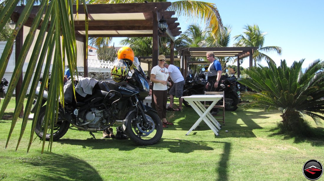Motorcycles parked near a pergola on perfectly manicured grass lawn