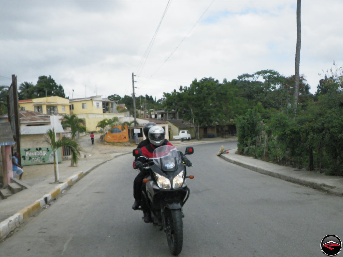 motorcycle riding through small town in the dominican republic