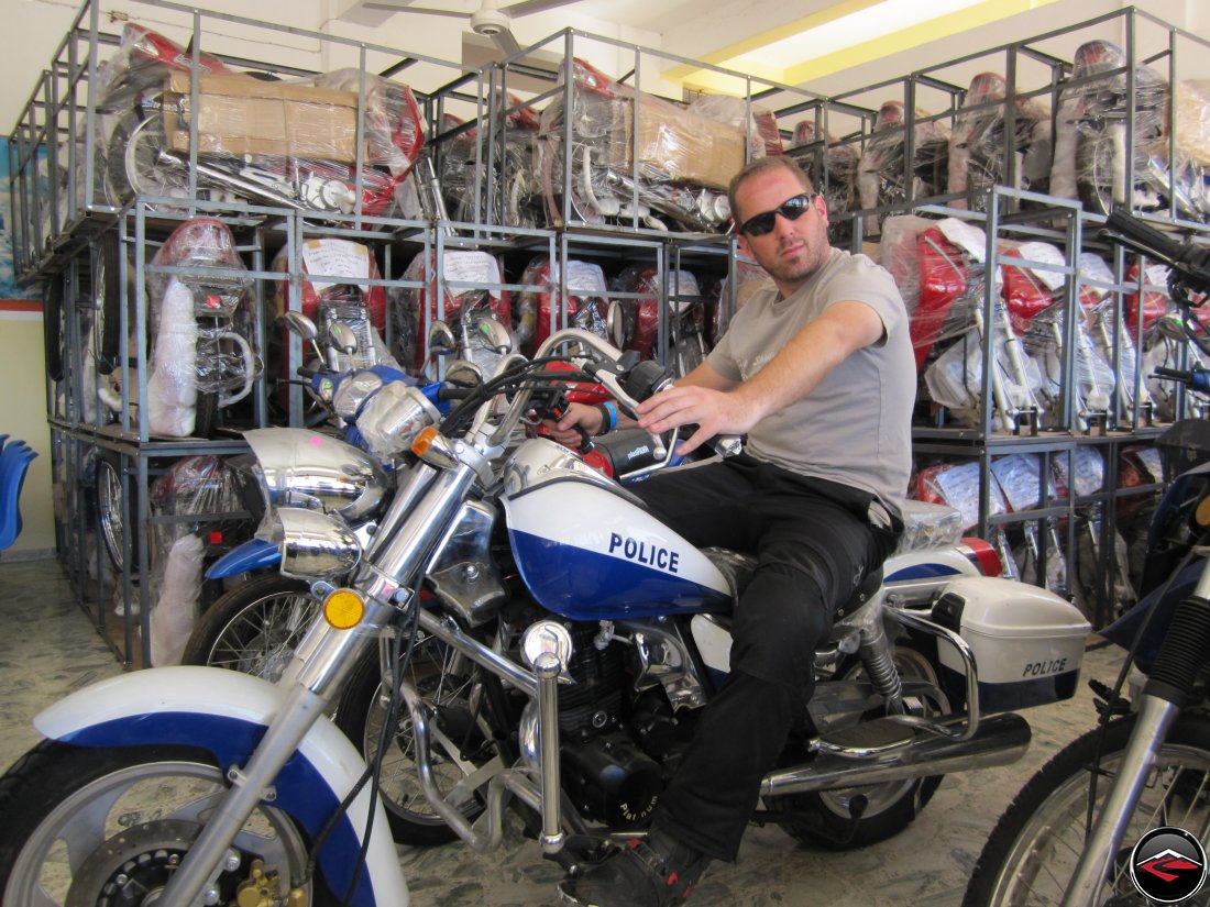 man sitting on a small police policia motorcycle