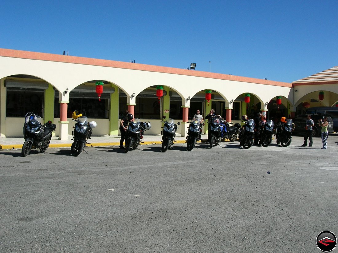 Motorcycles lined up in a parking lot