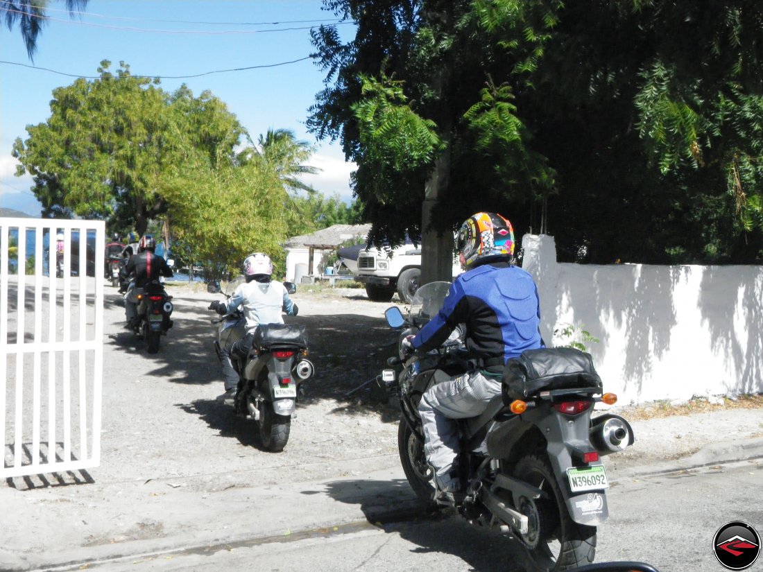 Motorcycles riding through an open gate