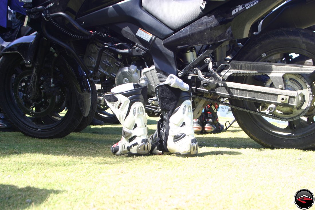 Boots left next to a parked motorcycle