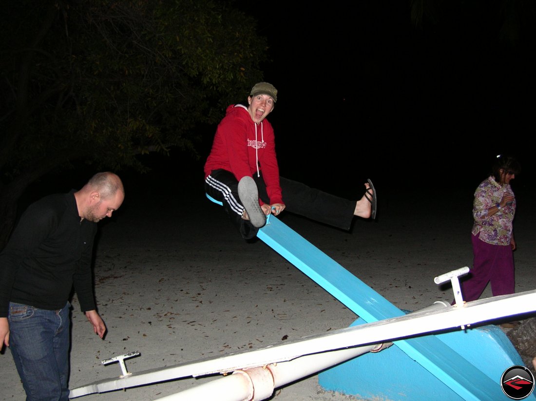 woman making a funny face while riding a see saw