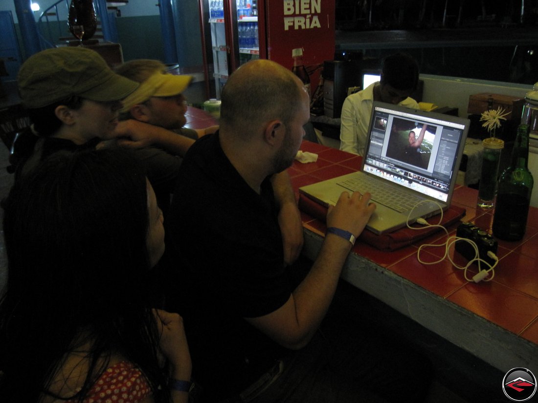 Gathered around a computer looking at photos