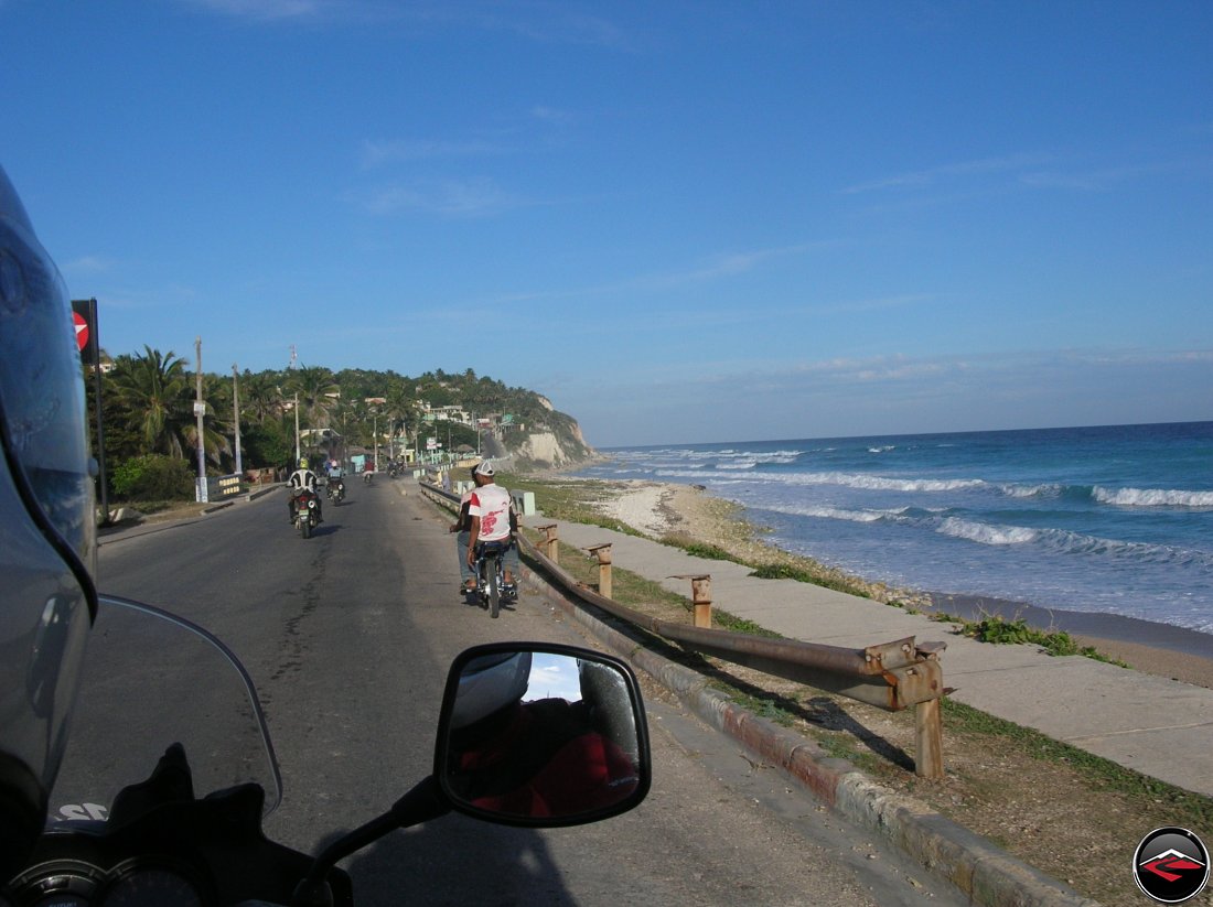 motorcycles riding along the southern coast of the dominican republic during sunset in the caribbean