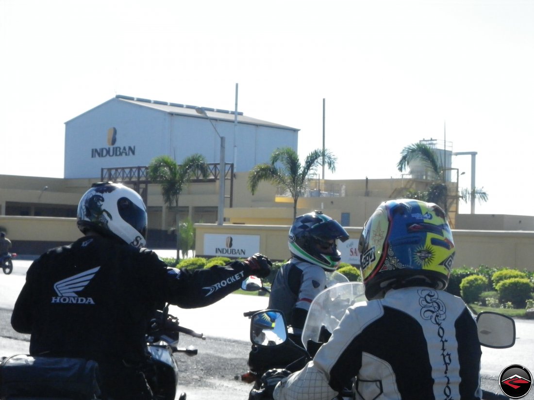 motorcycles stopped in front of industrial building induban