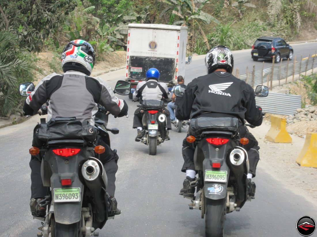 motorcycles stuck behind a slow miving truck