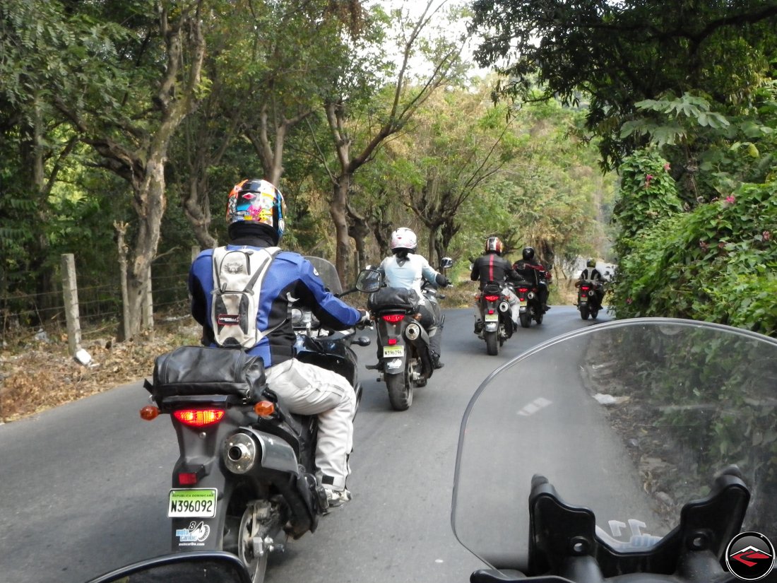 motorcycles riding very slowly in a line