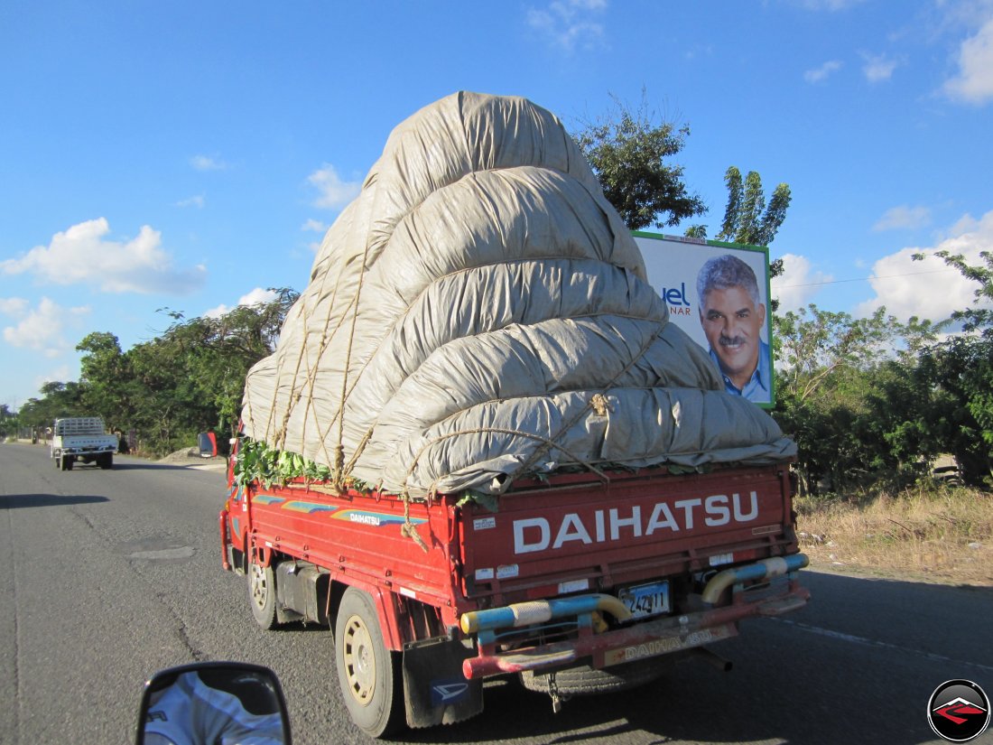 Daihatsu truck hauling very large argicultural load