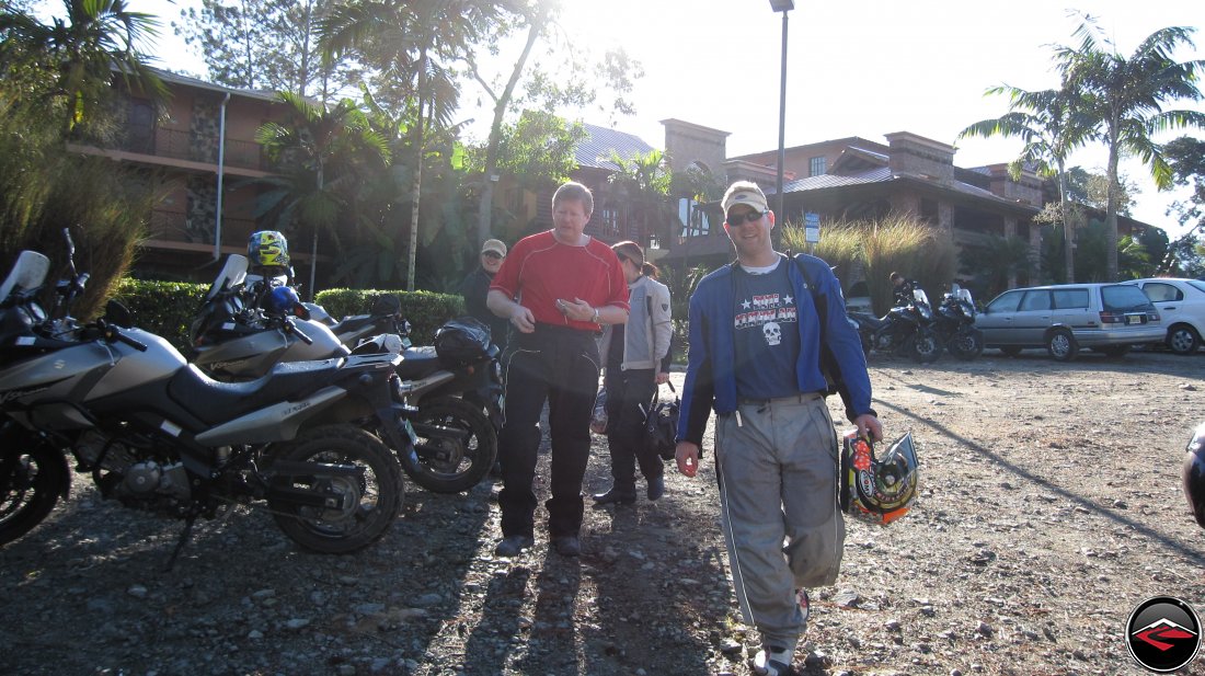 men walking past motorcycles