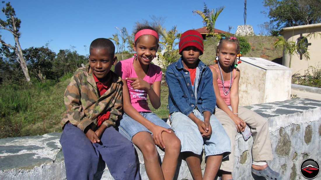 children sitting on a wall