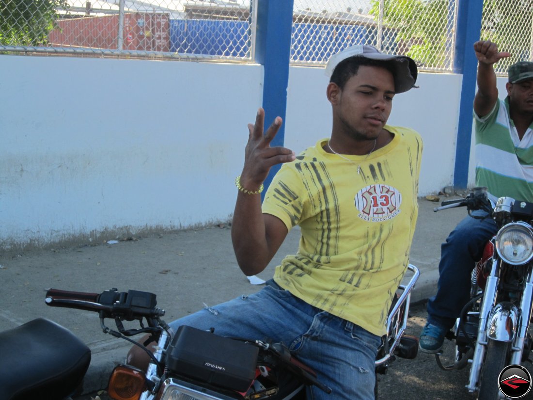 Man striking a funny pose on a motorcycle