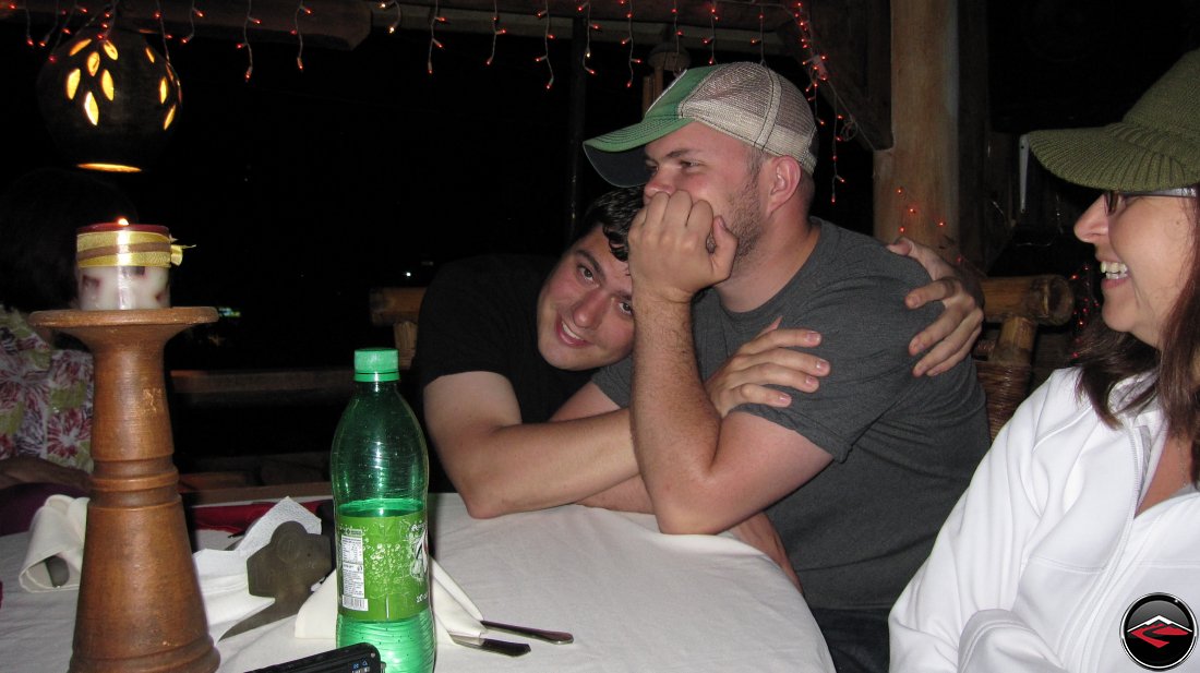 two men cuddling at the dinner table