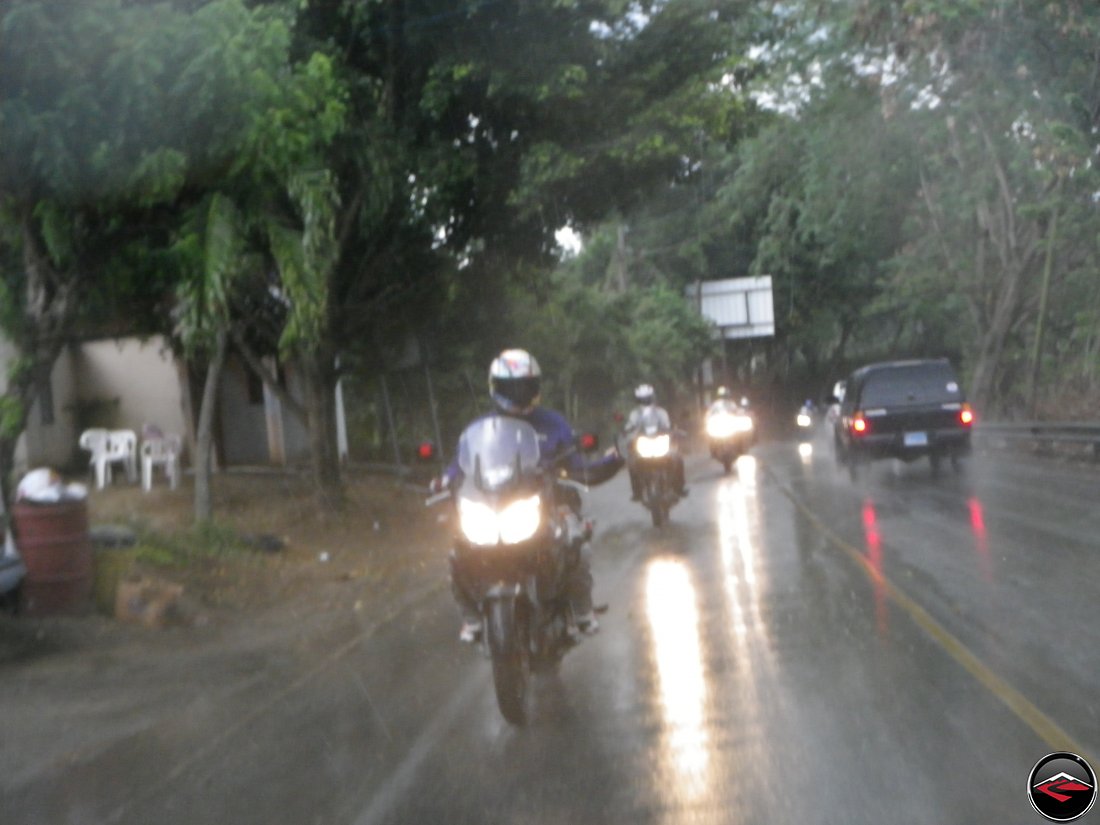 motorcycles riding in the heavy rain