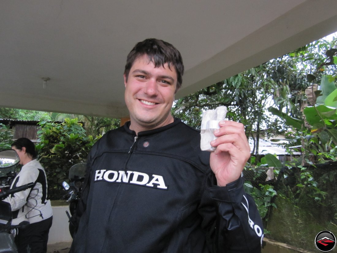 man holding a tattered role of toilet paper