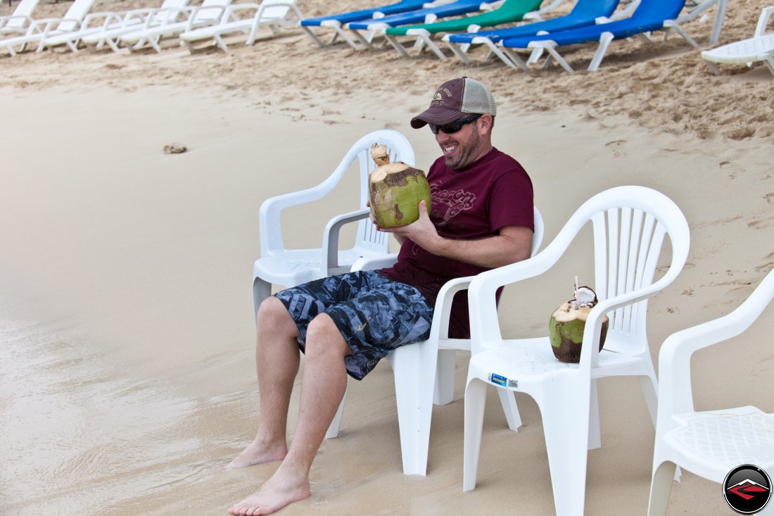 man really excited to be drinking a pina coloda made out of a coconut Playa Rincon Dominican Republic