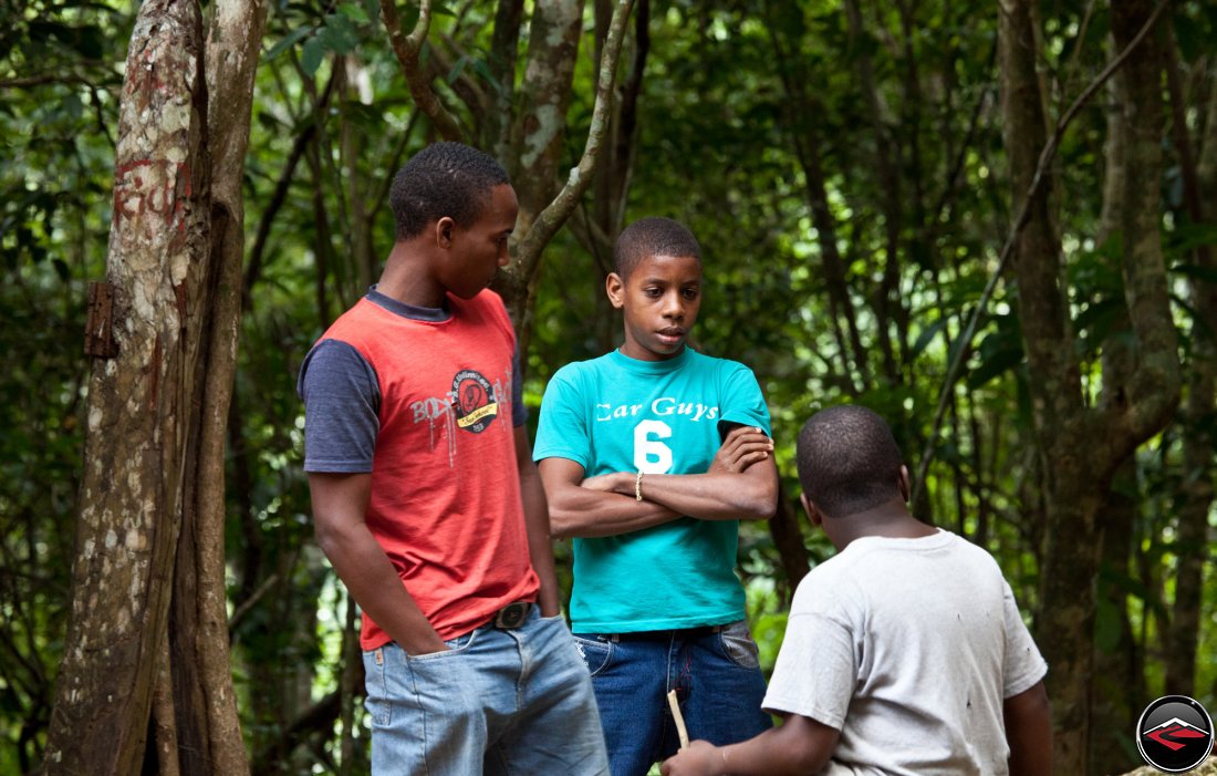 three young dominican republic boys standing in a grove of dense vegetation Cascada El Limon Dominican Republic