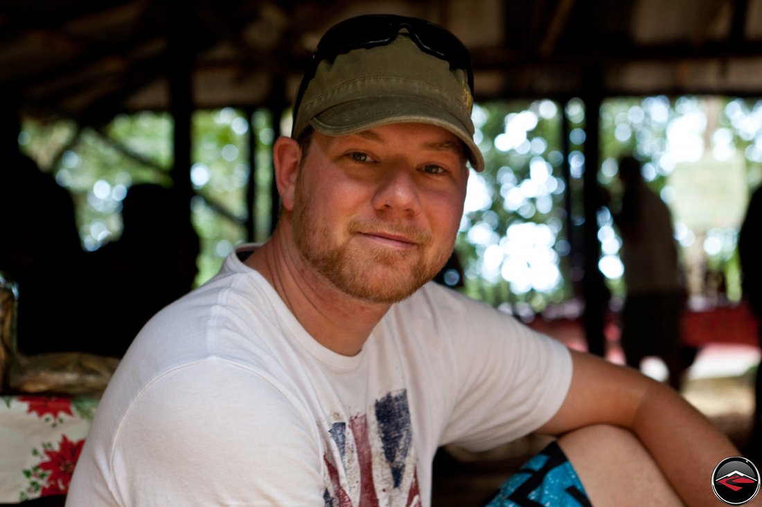 Portrait of a man sitting under an awning in the jungle Cascada El Limon Dominican Republic