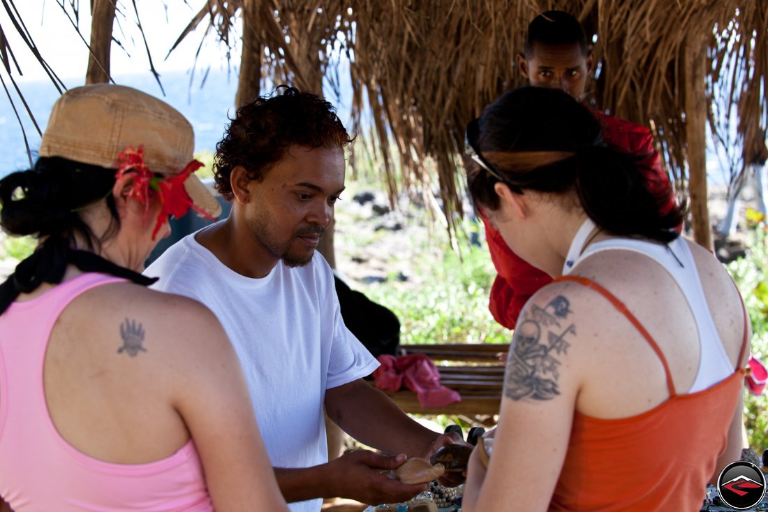 woman shopping for items being sold by local street vendor