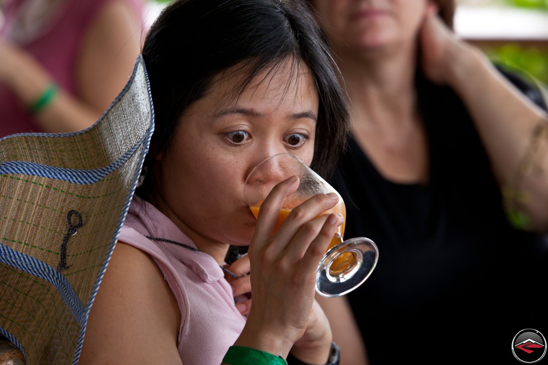 Girl making a funny face while drinking juice!