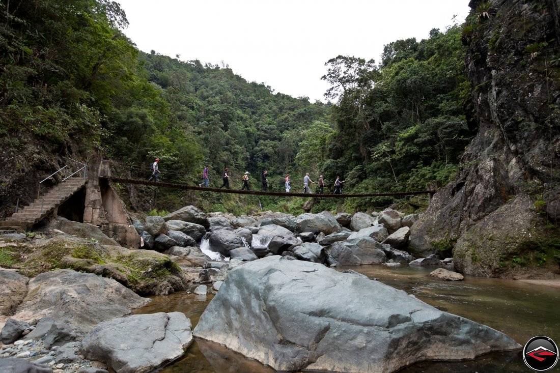 Handmade concrete, wood and cable bridge spanning a river in the Dominican Republic