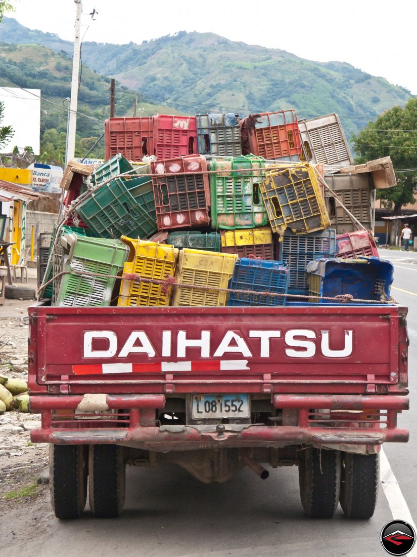 Daihatsu pikcup hauling lots of empty crates