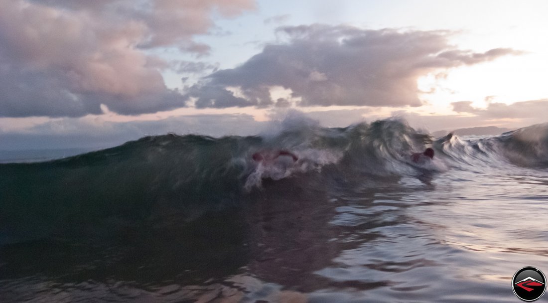 man body surfing in the ocean La Tambora Beach Resort