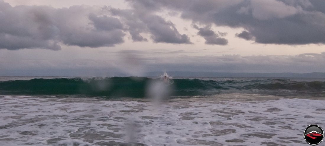 Man body surfing in the ocean La Tambora Beach Resort