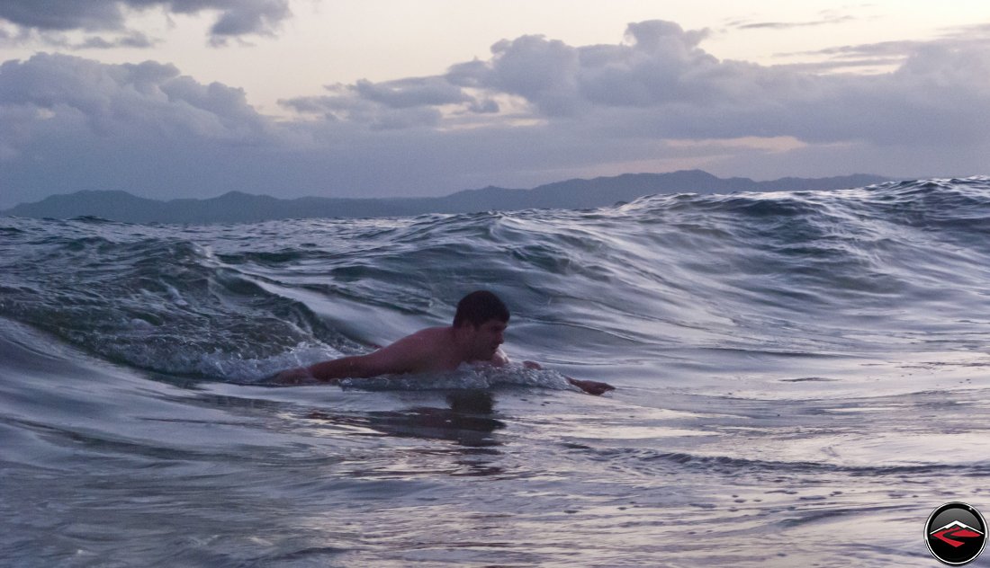 Man body surfing in the ocean La Tambora Beach Resort