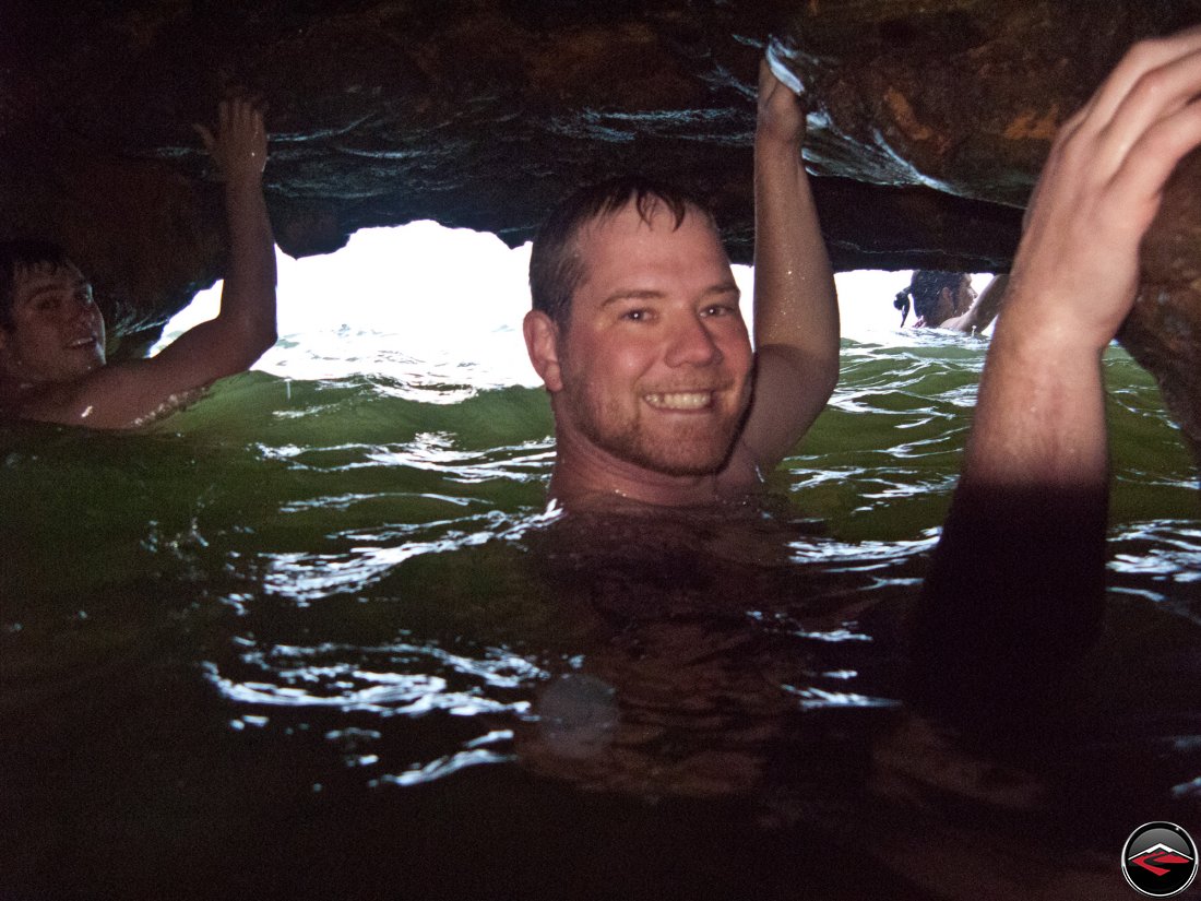 Men up to their necks in a water cave Cascada El Limon Dominican Republic