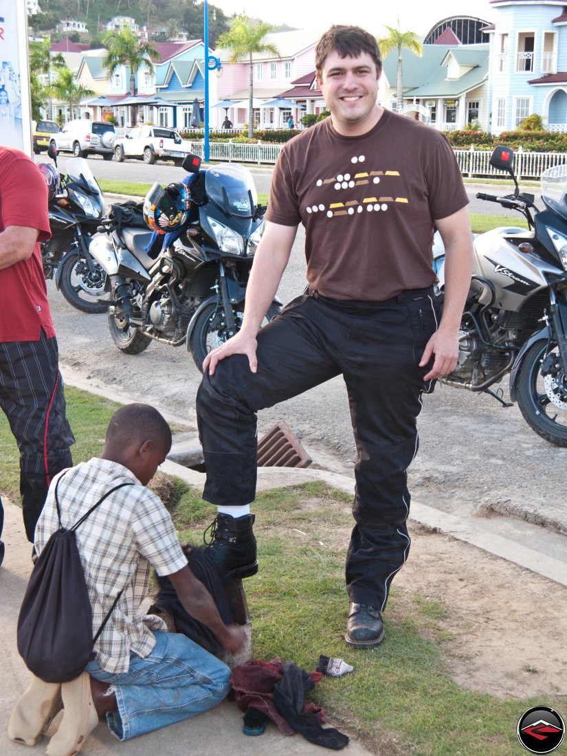 warren getting a shoe shine from local dominican republic boy