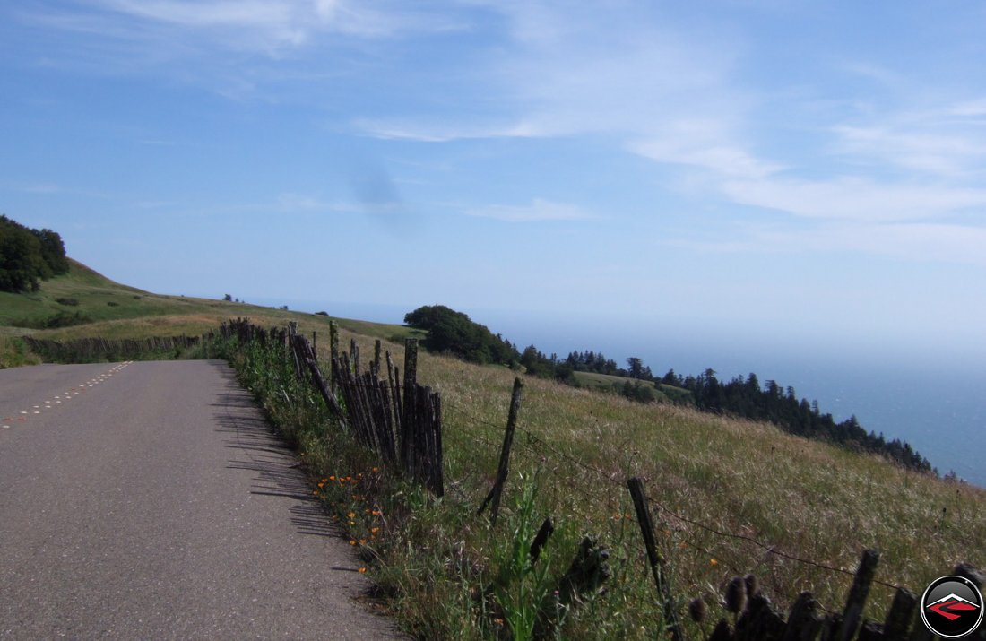 Narrow, windy, Pacific Coast Highway in northern California with the Pacific Ocean barely visible behind a layer of fog