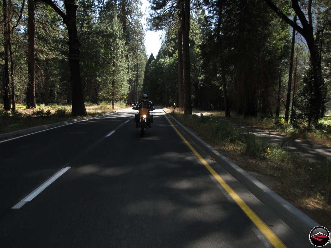 Tom riding his Buell Ulysses in the shade on the ashphalt in California's Yosemite National Park, Southside Drive