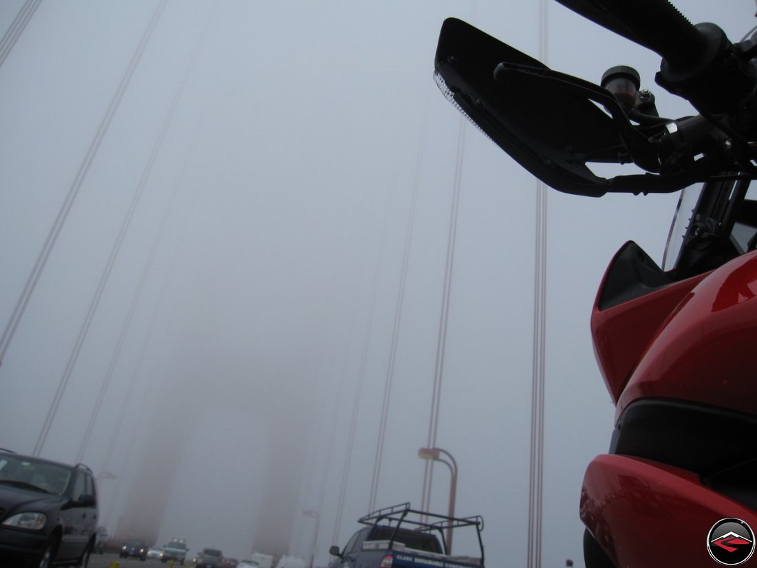 Riding a Ducati Multistrada 1200 motorcycle across the Golden Gate Bridge, in California, in the fog