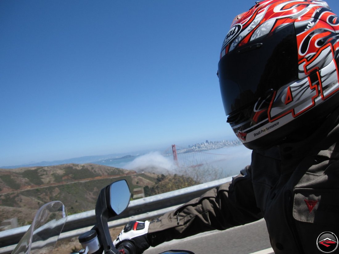 Riding a Ducati Multistrada 1200 motorcycle down California Conzelman Road, in the Golden Gate National Recreation Area, overlooking San Francisco and the Golden Gate Bridge, wearing an Haga replica Arai Helmet