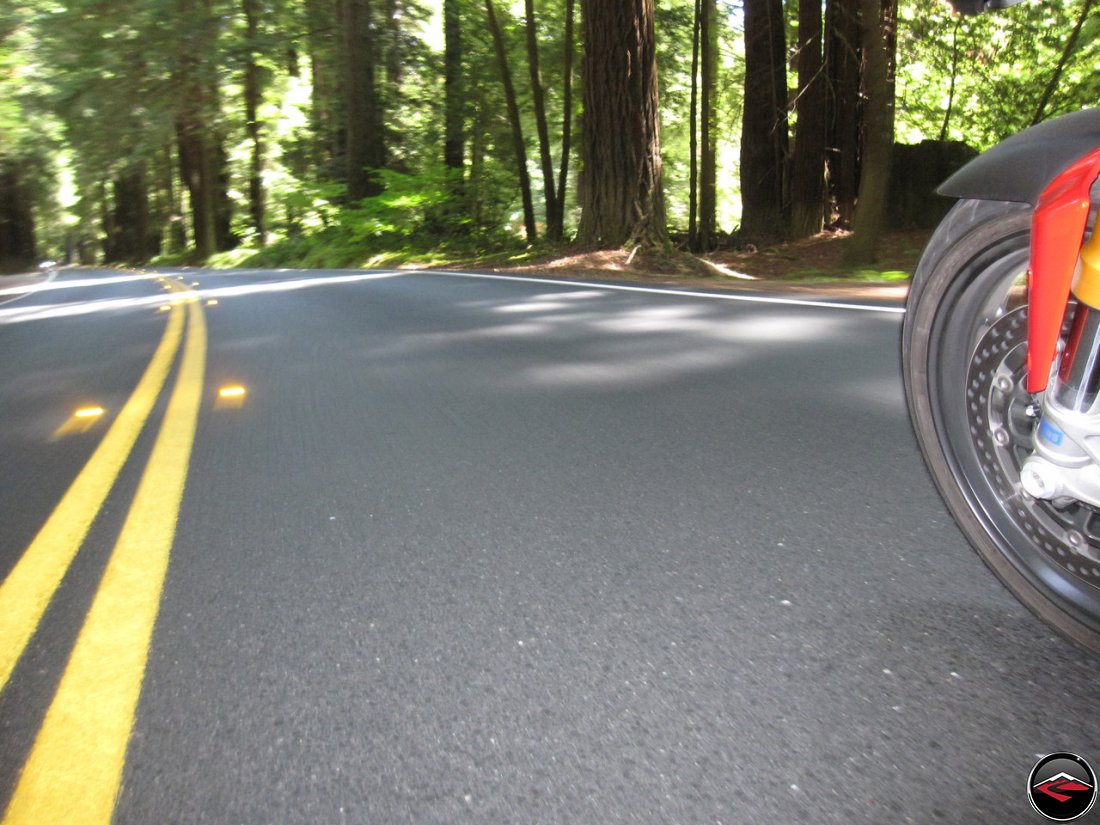 Riding a Ducati Multistrada 1200 through Dense Redwood Tree's inside Navarro River Redwoods State Park in California