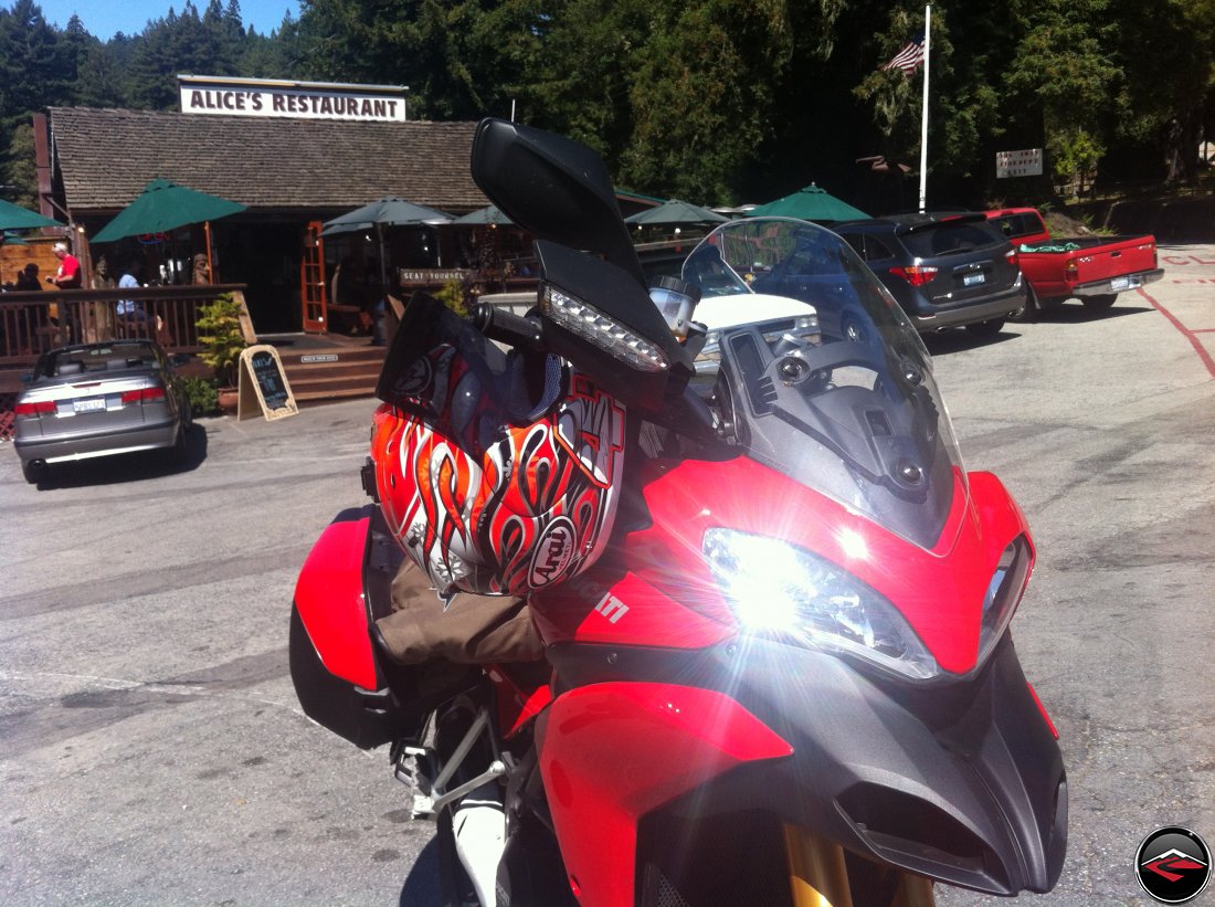 Ducati Multistrada 1200, with headlight gleam and glint, parked in front of Alices Restaurant along California Highway 35, Skyline Blvd, and Highway 84, La Honda Road. Haga replica Arai Helmet 