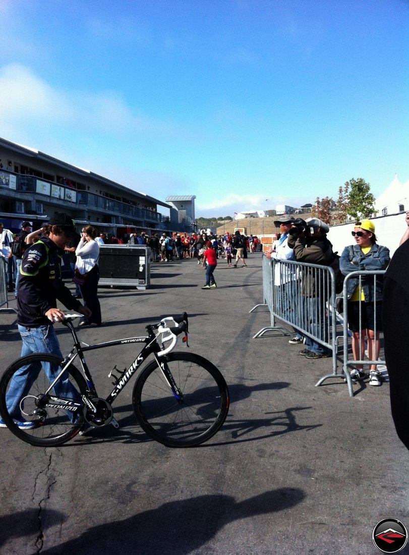 Cal Crutchlow, MotoGP Tech3 Rider, pushes his Specialized S-Works bicycle across the paddock