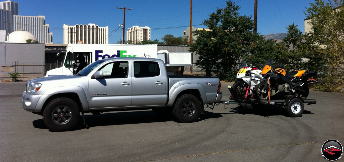 Toytoa Tacoma hauling three motorcycles on a 3-rail trailer; a Buell Ulysses, a Honda VTR1000 SP1 and a Ducati Multistrada 1200